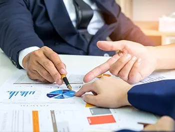 A bunch of people discussing over a graph