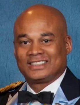 A man in military uniform smiling for the camera.